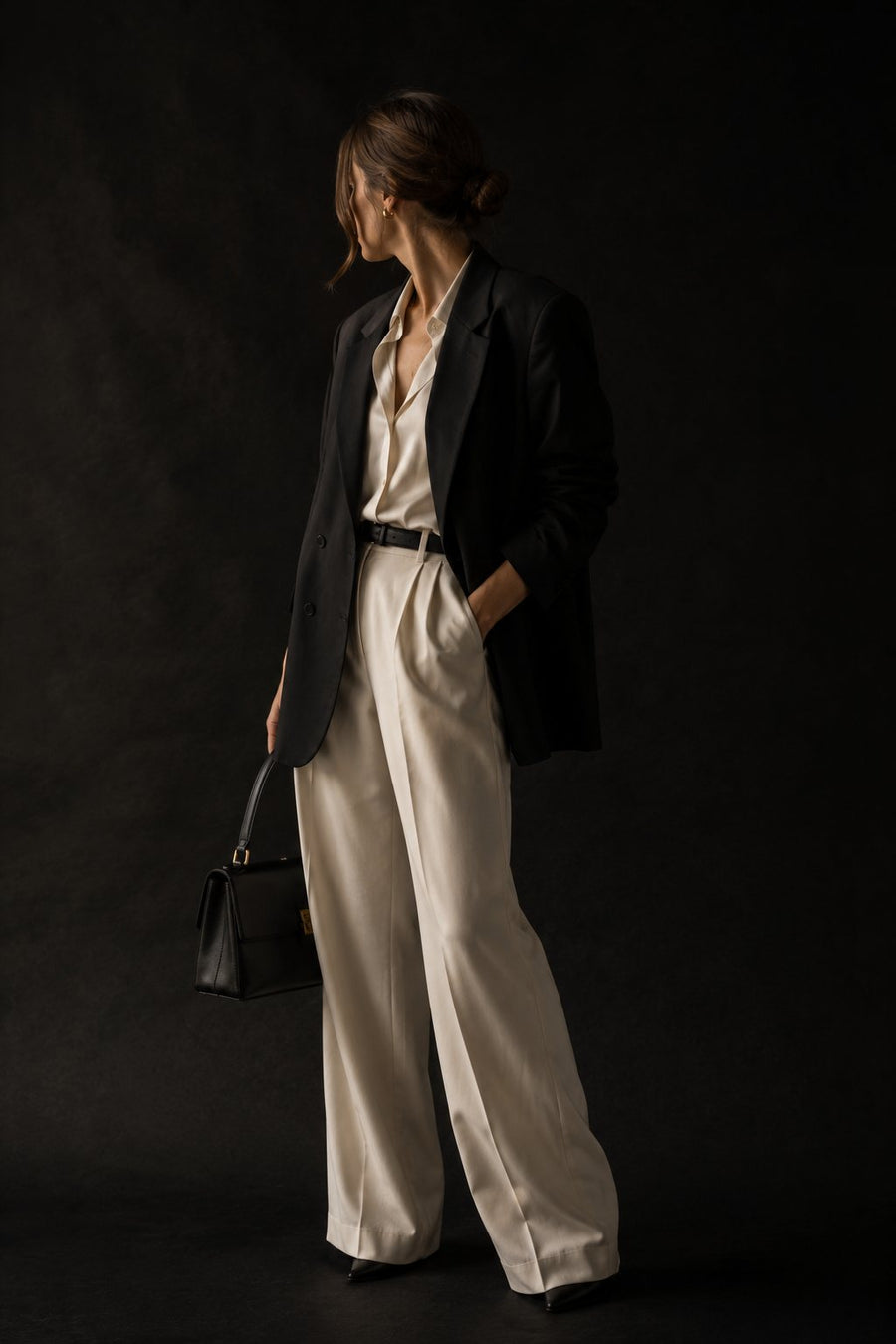 A styled outfit, black blazer over cream trousers